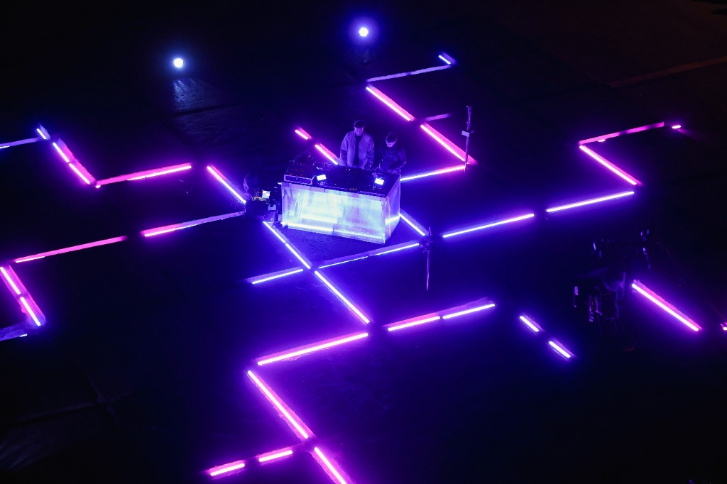 Top down shot of DJ desk with neon pink cross