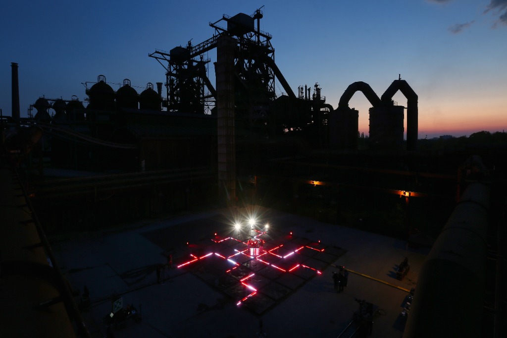 Wide shot of light pillar and ground neon cross